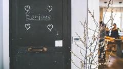 Stock image of a door with bonjour marked in chalk