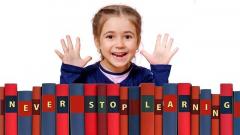 Stock image of a girl wearing over a stack of books with the caption never stop learning