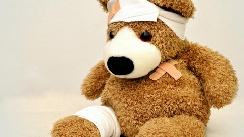 Stock images of a teddy bear wearing bandages and elastoplasts